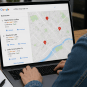 Small business owner checking local Google search results and business rankings on a laptop.
